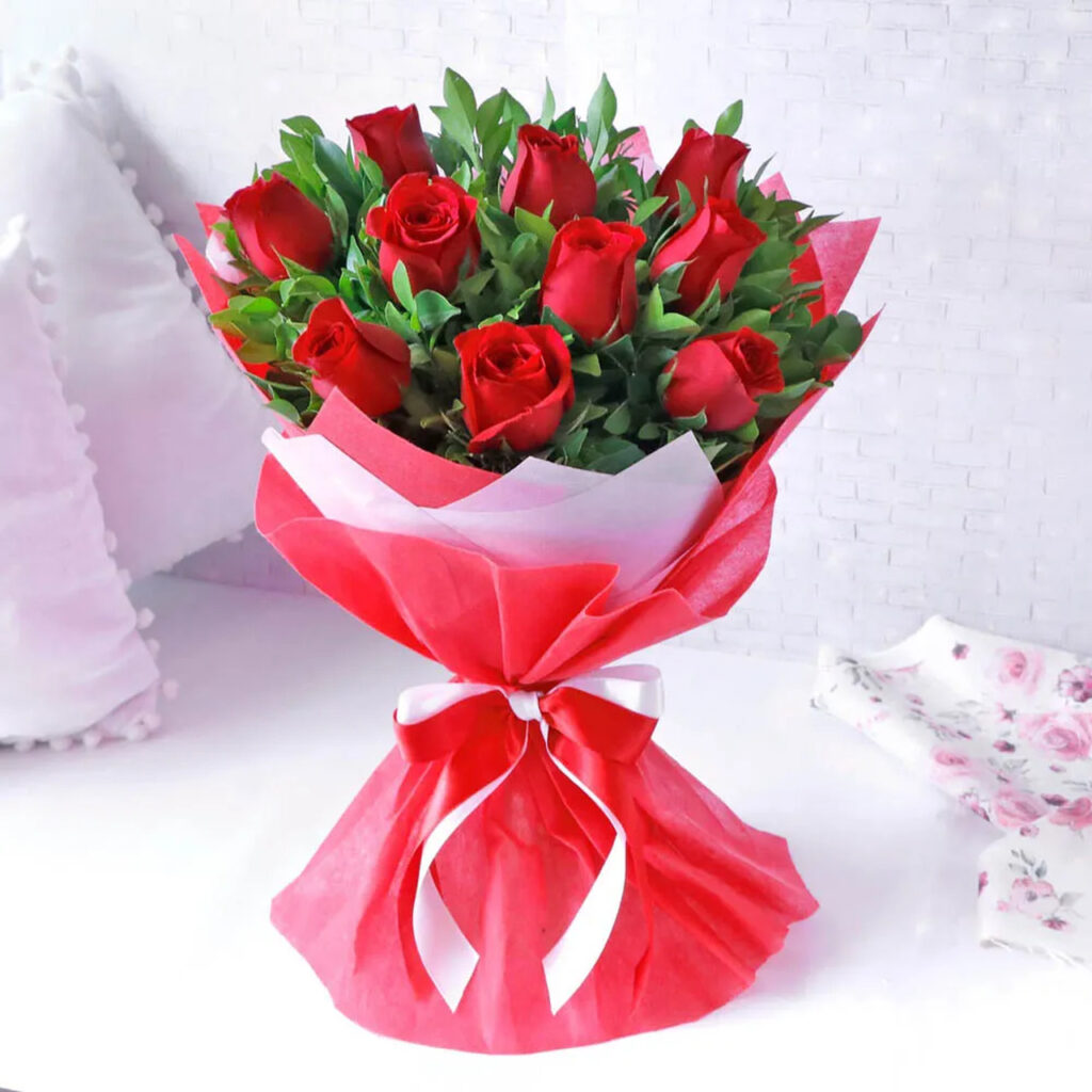 bunch of red roses in paper packing