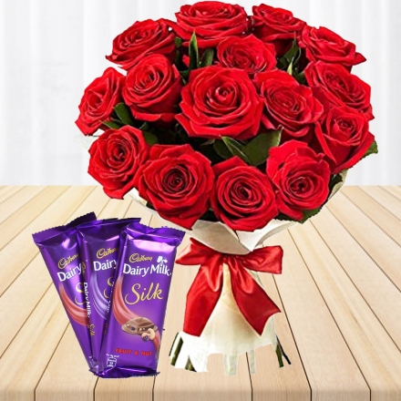 red roses bunch with silk chocolates